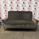grey velvet two-seater sofa with wooden legs